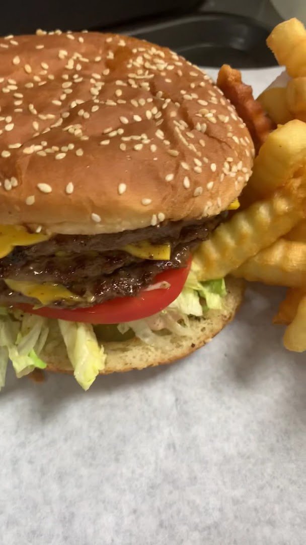 Hamburgers and fries on a casual restaurant table.